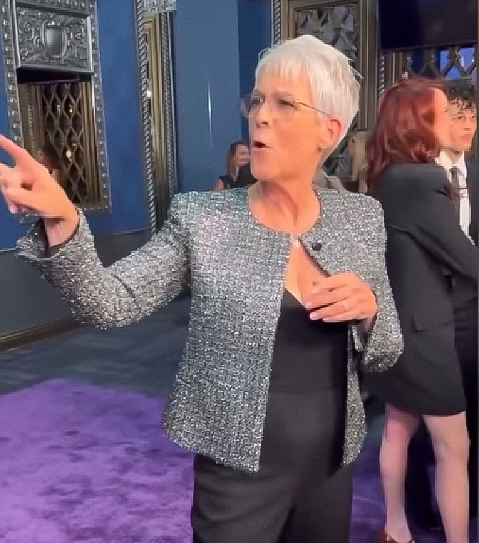Jamie Lee Curtis reacting animatedly on the red carpet wearing a glittery jacket and black outfit at a formal event. - 4