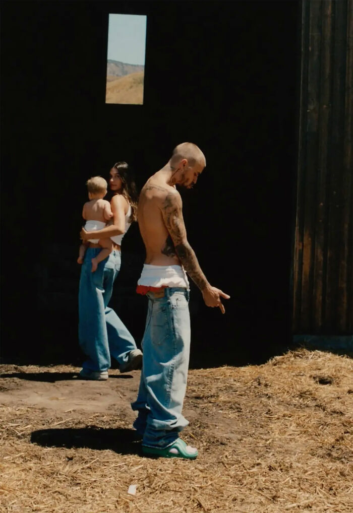 Justin and Hailey Bieber with child standing apart in a dimly lit barn highlighting their troubled marriage factor. Justin and Hailey Bieber with child standing apart in a dimly lit barn highlighting their troubled marriage factor.