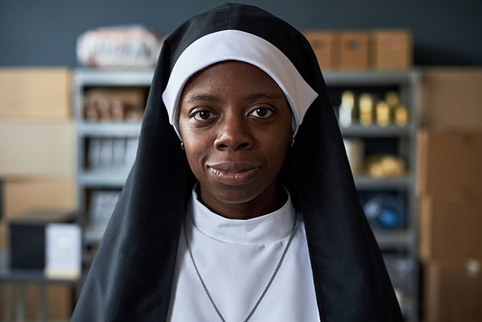 Portrait of a black woman dressed as a nun, representing diversity and identity in parenting embarrassing moments.