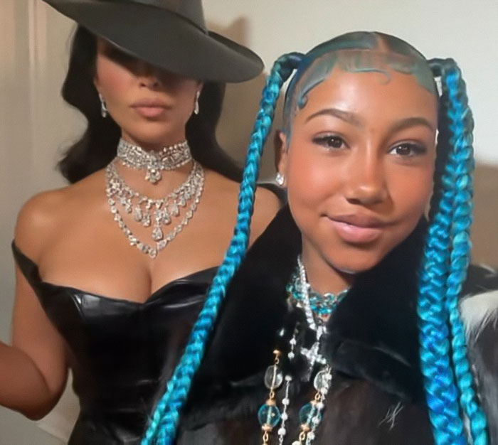 Kim Kardashian and daughter North West wearing bold fashion, with North in a corset sparking disturbing controversy online.