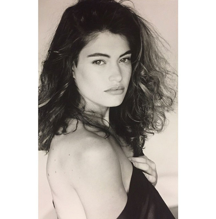 Black and white portrait of Kimberly Guilfoyle with voluminous hair, showcasing her before and after transformation era.