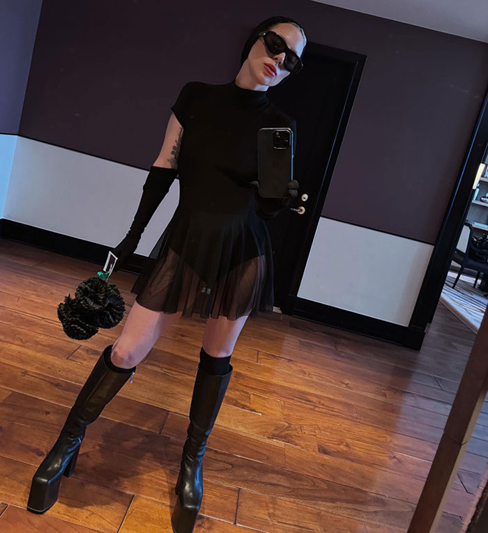Lady Gaga taking a mirror selfie wearing a black dress and boots amid backlash over ageist and misogynistic comments. - 12
