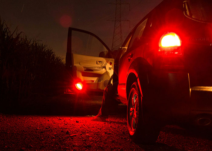 Truck drivers facing terrifying road encounters at night with their vehicles stopped on a dark, remote road.
