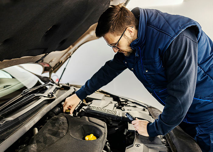 Man inspecting car engine, discovering a clever loophole to fix or optimize the vehicle efficiently.