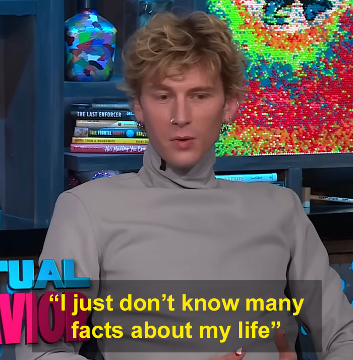 MGK in an interview claiming he's half alien and unsure about his age, addressing personal life questions.