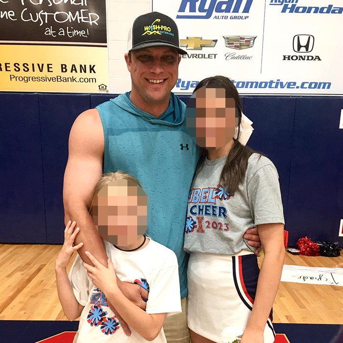 Man with two children in a gym, blurred faces, related to father-of-two assault after breast milk dispute news.