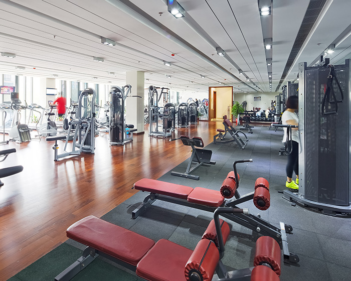 Modern gym interior with workout machines and benches, illustrating man spending $120k on gym membership issues. Modern gym interior with workout machines and benches, illustrating man spending $120k on gym membership issues.