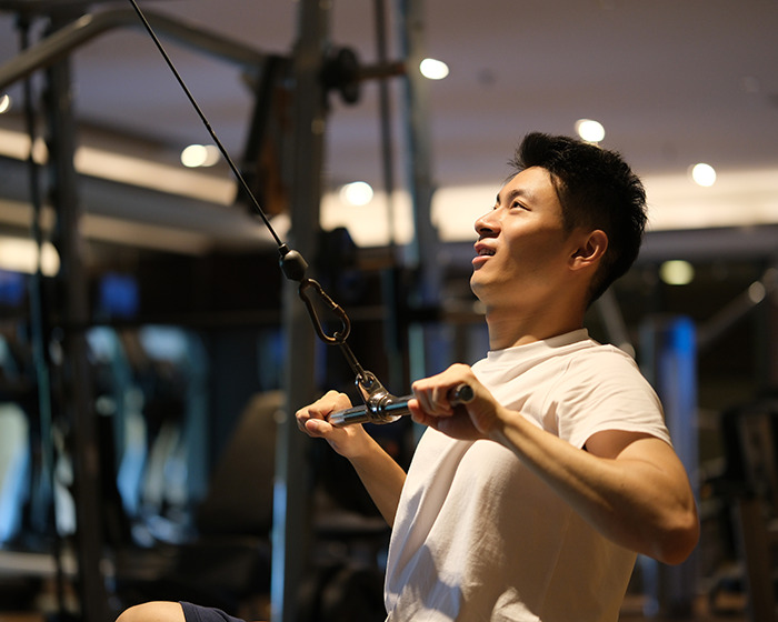 Young man using gym equipment during workout session, highlighting gym membership experience and management issues. Young man using gym equipment during workout session, highlighting gym membership experience and management issues.
