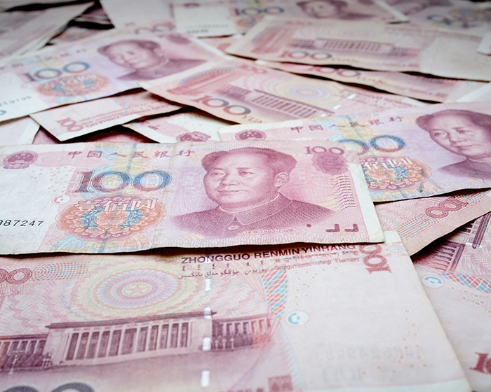 Multiple 100 yuan Chinese banknotes spread out, representing a man spending $120k on gym membership money. Multiple 100 yuan Chinese banknotes spread out, representing a man spending $120k on gym membership money.