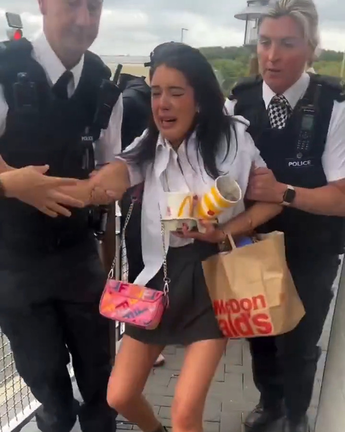 Police officers detain a distressed teenage girl at McDonald's amid heated two tier policy debate.
