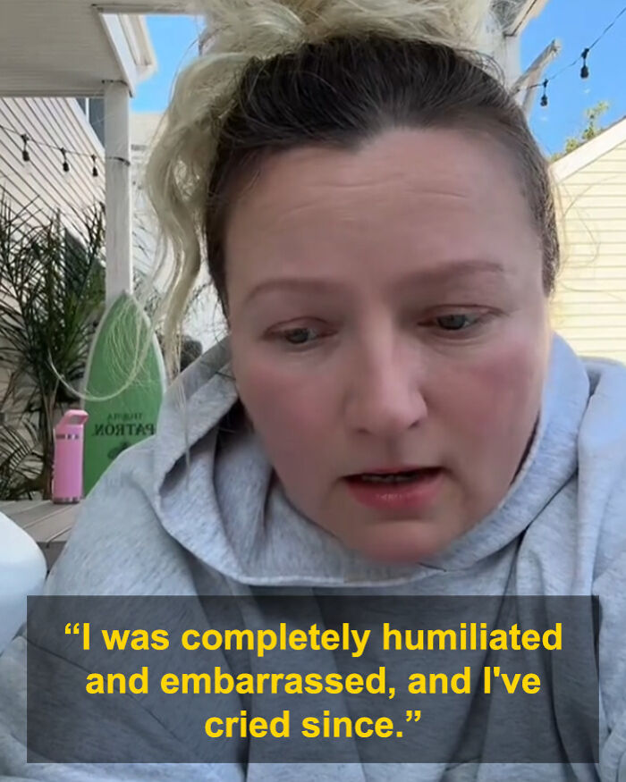 Woman in a hoodie expressing distress about a 3YO breaking $1,600 table at caf&eacute; and a credit card dispute.