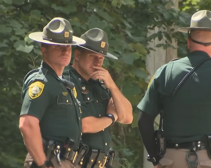 Three police officers in uniform at a scene investigating a depressed mom who ended life of her family case.