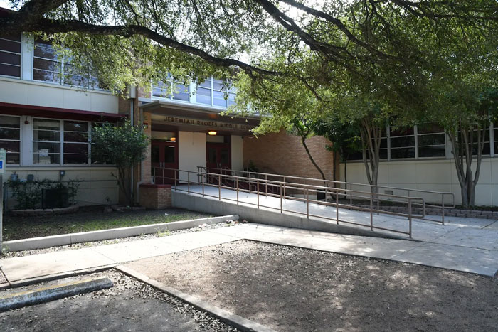 Exterior view of a middle school building surrounded by trees, related to mass school shooting planning incident. - 6