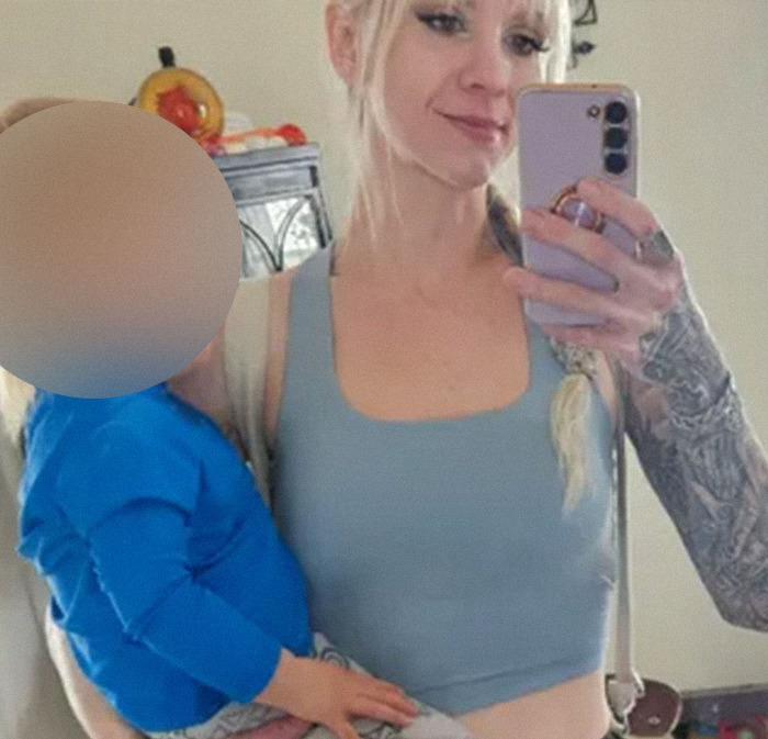 Mom holding autistic child taking a selfie, related to viral video and criminal charges news. Mom holding autistic child taking a selfie, related to viral video and criminal charges news.