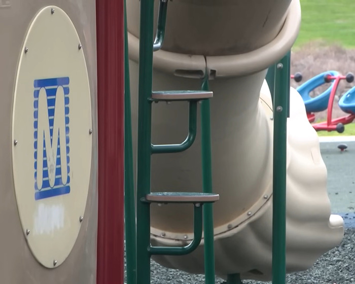 Playground climbing structure and slide at a park, related to mom who called autistic child n-word facing criminal charges. Playground climbing structure and slide at a park, related to mom who called autistic child n-word facing criminal charges.