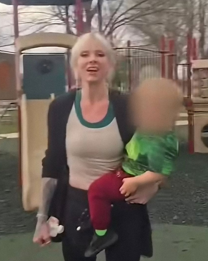 Woman at a playground holding a child with blurred face in a viral video involving autistic child criminal charges. Woman at a playground holding a child with blurred face in a viral video involving autistic child criminal charges.