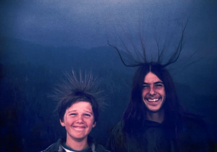 Two boys with hair standing on end in a photo taken before disaster, suggesting impending unfortunate events.