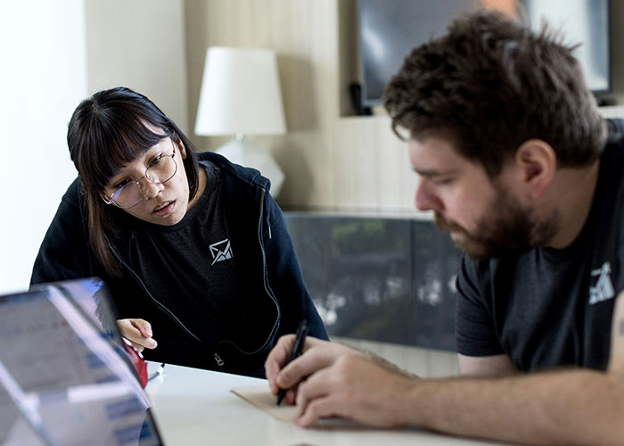 Two people discussing and taking notes in a casual setting, demonstrating mind tricks that actually work techniques. - 2