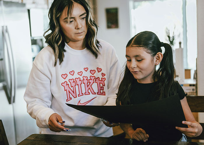 Woman teaching a young girl at home using creative mind tricks that actually work for learning and focus. - 11