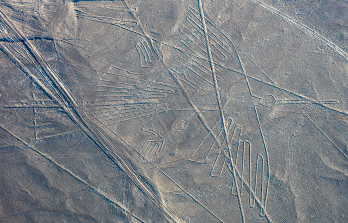 Aerial view of an ancient geoglyph in desert terrain, highlighting AI's role in discovering 303 geoglyphs globally.