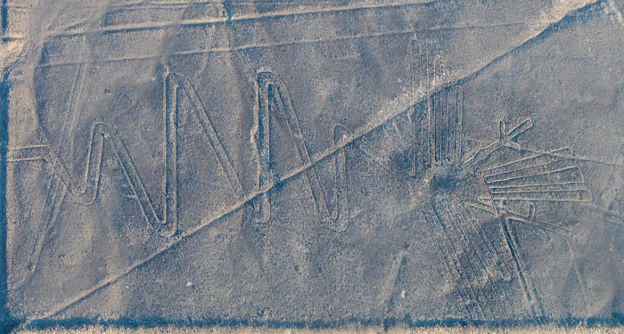 Aerial view of ancient geoglyphs in desert terrain, showcasing AI-assisted discovery of 303 geoglyphs puzzle.