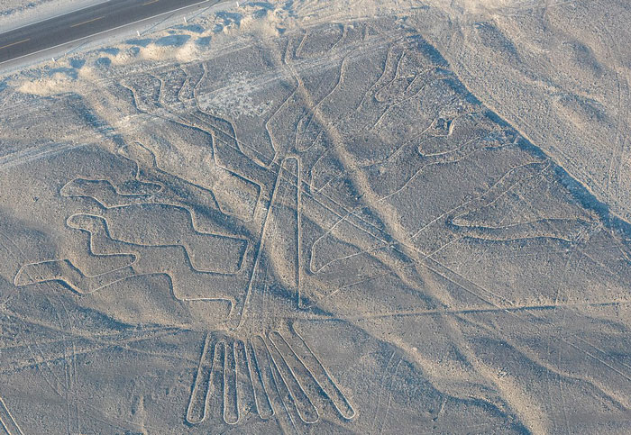 Aerial view of ancient geoglyphs etched in the desert, showcasing mysterious large-scale earth drawings discovered by AI.