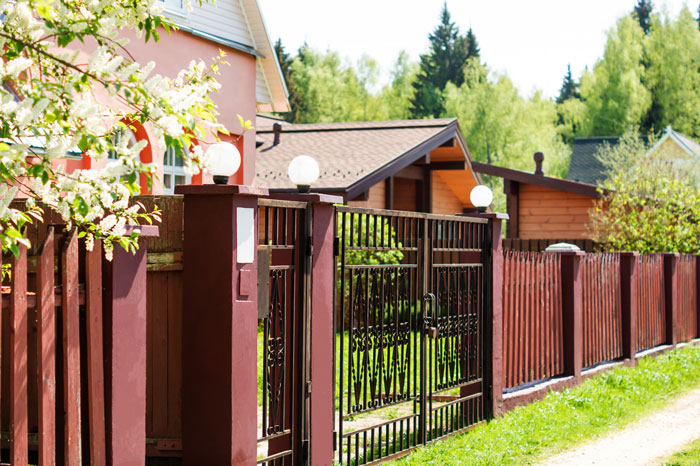 Wooden fence and gate in suburban yard, illustrating homeowner laughs in entitled neighbor&rsquo;s face over fence dispute.