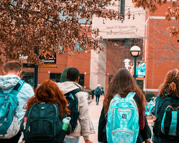 Teenagers walking on a campus path, illustrating new details after video of 13-year-old arrested sparked widespread outrage.
