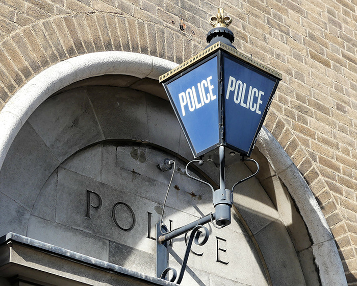 Police station lantern mounted on brick wall representing new details after video of 13-year-old arrest sparked outrage