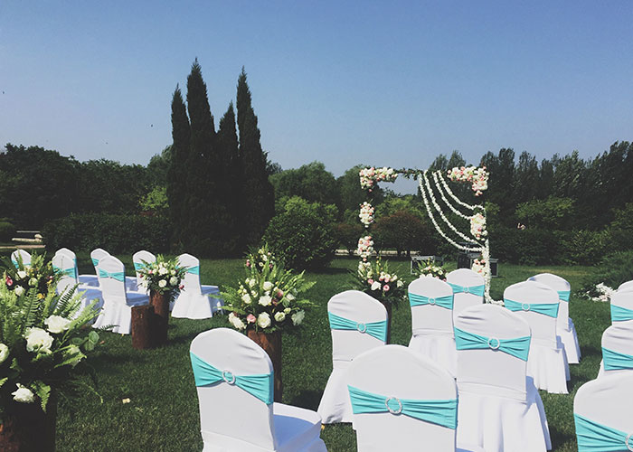 Outdoor wedding setup in a yard with white chairs and floral decorations reflecting a father-daughter relationship conflict.