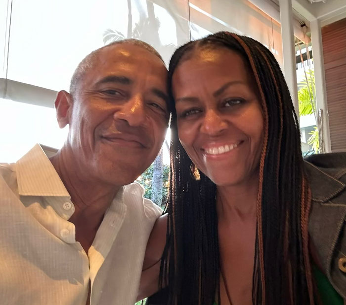 Barack Obama and Michelle Obama smiling together indoors, reflecting Barack Obama&rsquo;s net worth and global media shift.