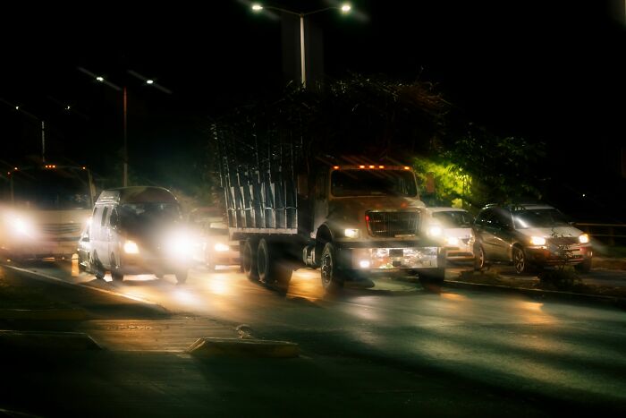 Nighttime traffic scene with cars and a truck, illustrating glitches in the matrix people experienced on the road.