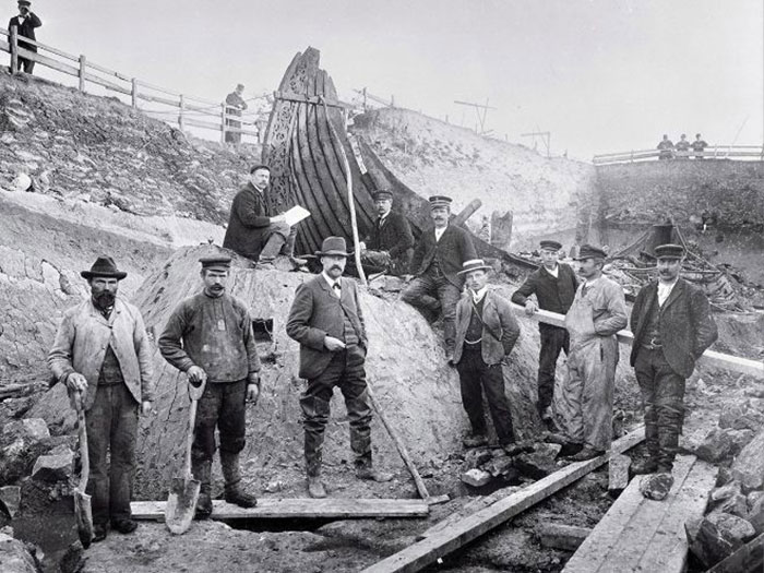 Group of workers and supervisors posing at an archaeological excavation site in a historical photo of weird and wild moments.