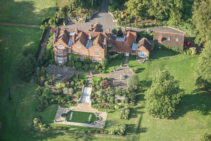 Aerial view of a large estate and garden, illustrating legal concerns when buying Ozzy Osbourne&rsquo;s house with grave backyard.