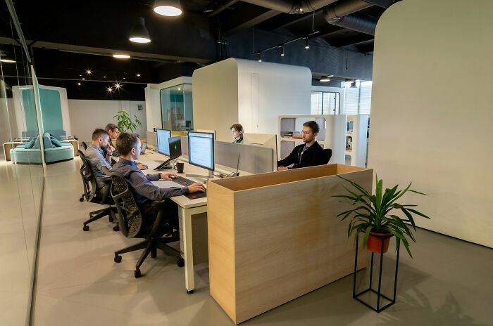 Open office space with employees at computers, illustrating job interview red flags and toxic workplace environment.