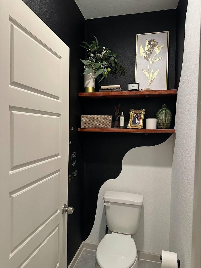Small bathroom decor pieces including floating wooden shelves with plants, framed art, and candles enhancing home magic.