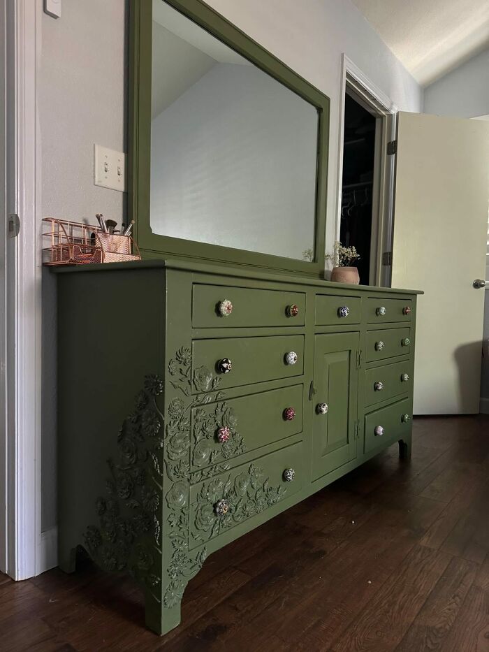 Green decorated dresser with floral knobs and matching mirror, a unique decor piece enhancing a magical home space.