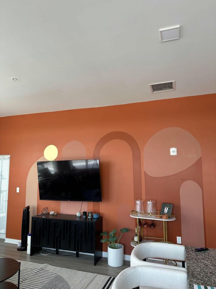 Living room with modern decor pieces including geometric wall art and stylish furniture enhancing a magical home ambiance.