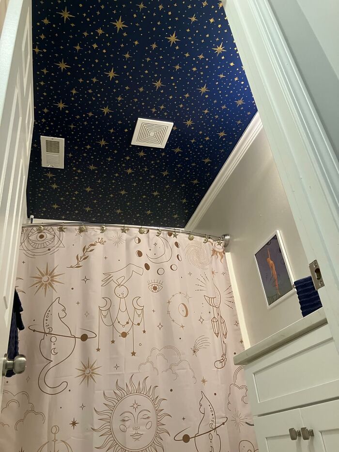 Bathroom with magical star decorated ceiling and mystical celestial shower curtain as unique decor pieces for home.