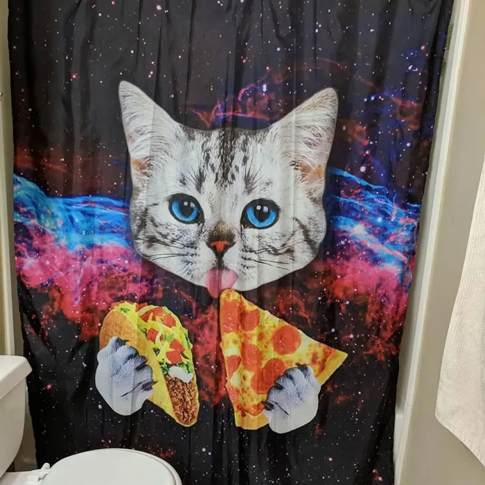Shower curtain with a magical space-themed design featuring a cat holding a taco and a slice of pizza decor piece.