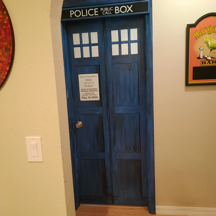 Blue police box door decor piece installed in home hallway, adding a magical and unique decorative touch.