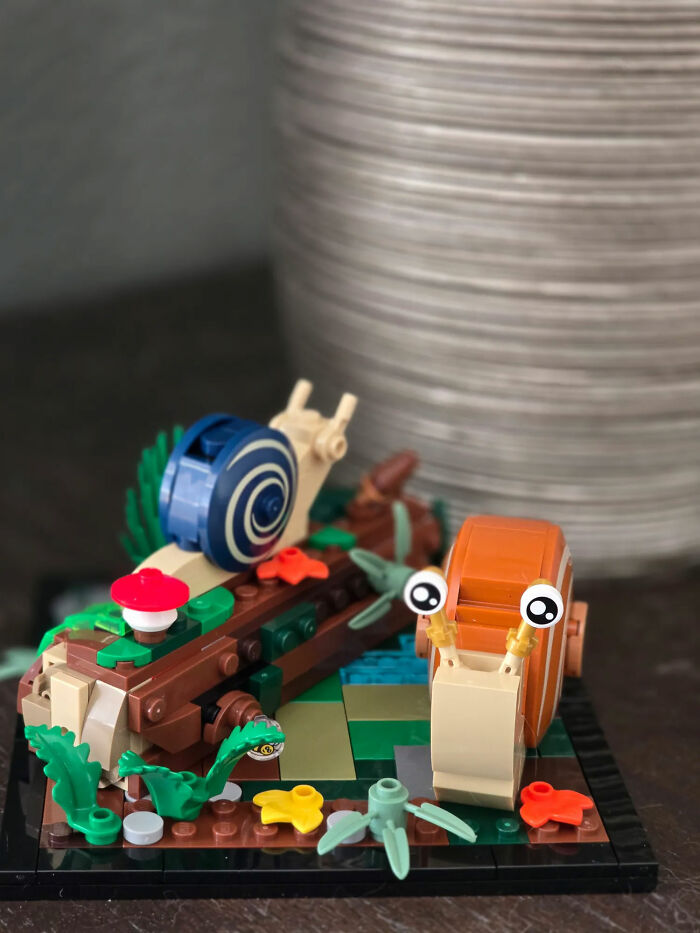 Colorful decor pieces of snails and plants made from building blocks displayed on a table enhancing magical home decor.