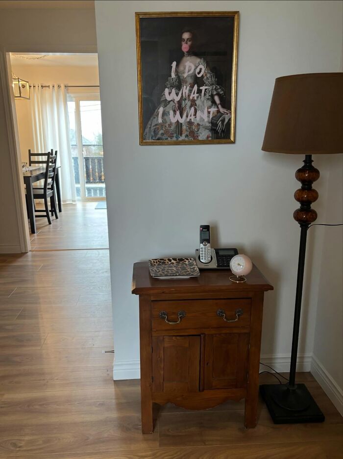 Vintage wooden side table with lamp, decorative tray, and unique wall art creating magical home decor ambiance.