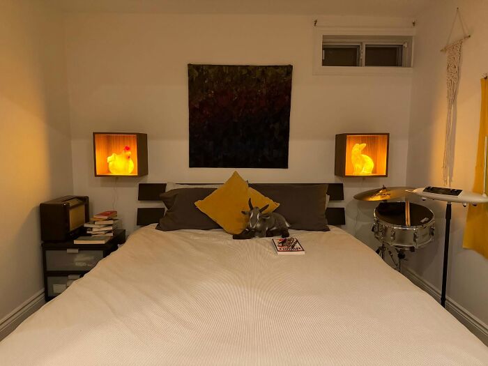 Cozy bedroom featuring magical decor pieces including illuminated animal lamps and artistic wall hanging for a warm ambiance.