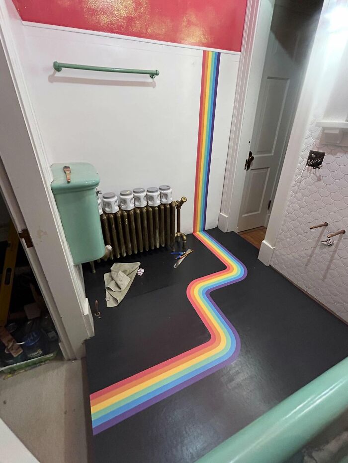 Colorful rainbow floor and wall decor piece in a vintage-style bathroom transforming home interiors magically.