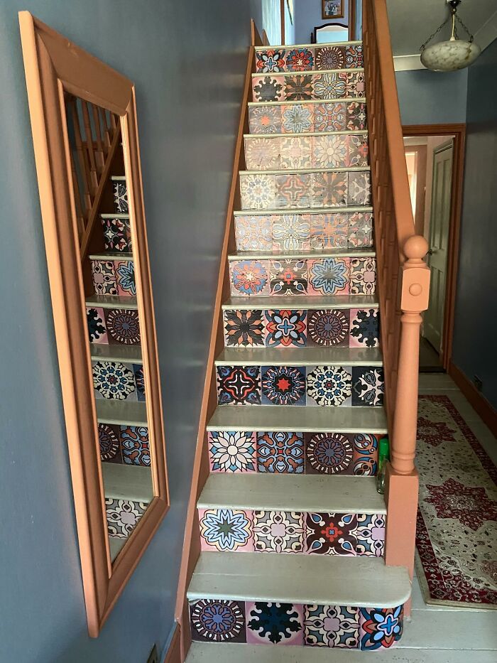 Staircase with colorful patterned tile decor pieces enhancing a home’s magical and artistic interior design.