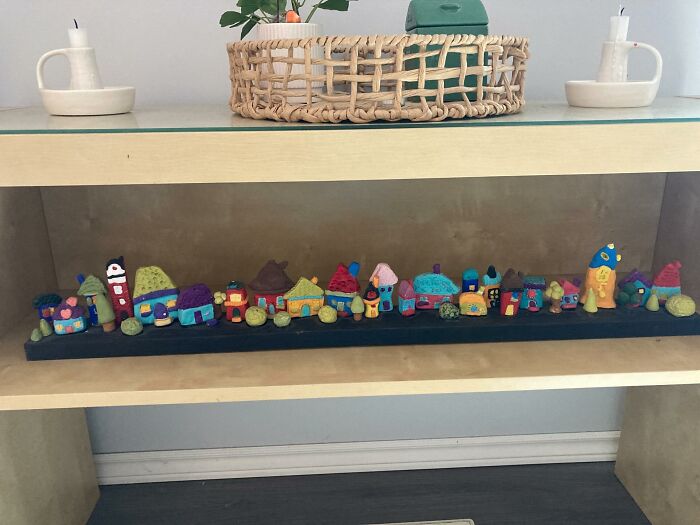 Colorful miniature decor pieces arranged on a shelf, adding charm and magic to homes with unique design elements.