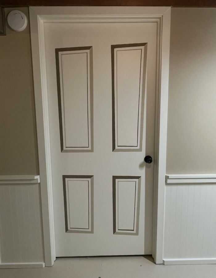 Door with painted decorative 3D panels creating a unique and magical decor piece in a home interior hallway.