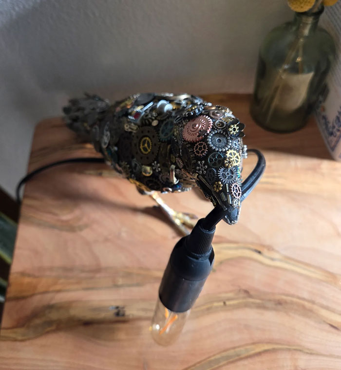 Decor piece of a steampunk bird lamp with gears and cogs, adding a magical touch to home decor pieces.