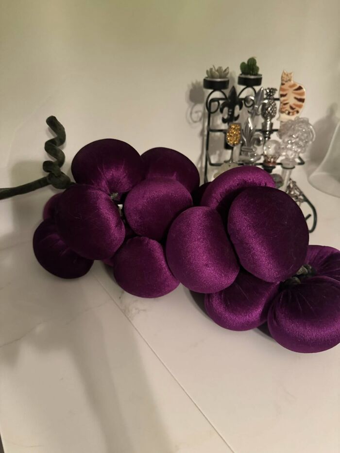 Plush purple velvet grape decor piece on a kitchen counter enhancing magical home decor style.